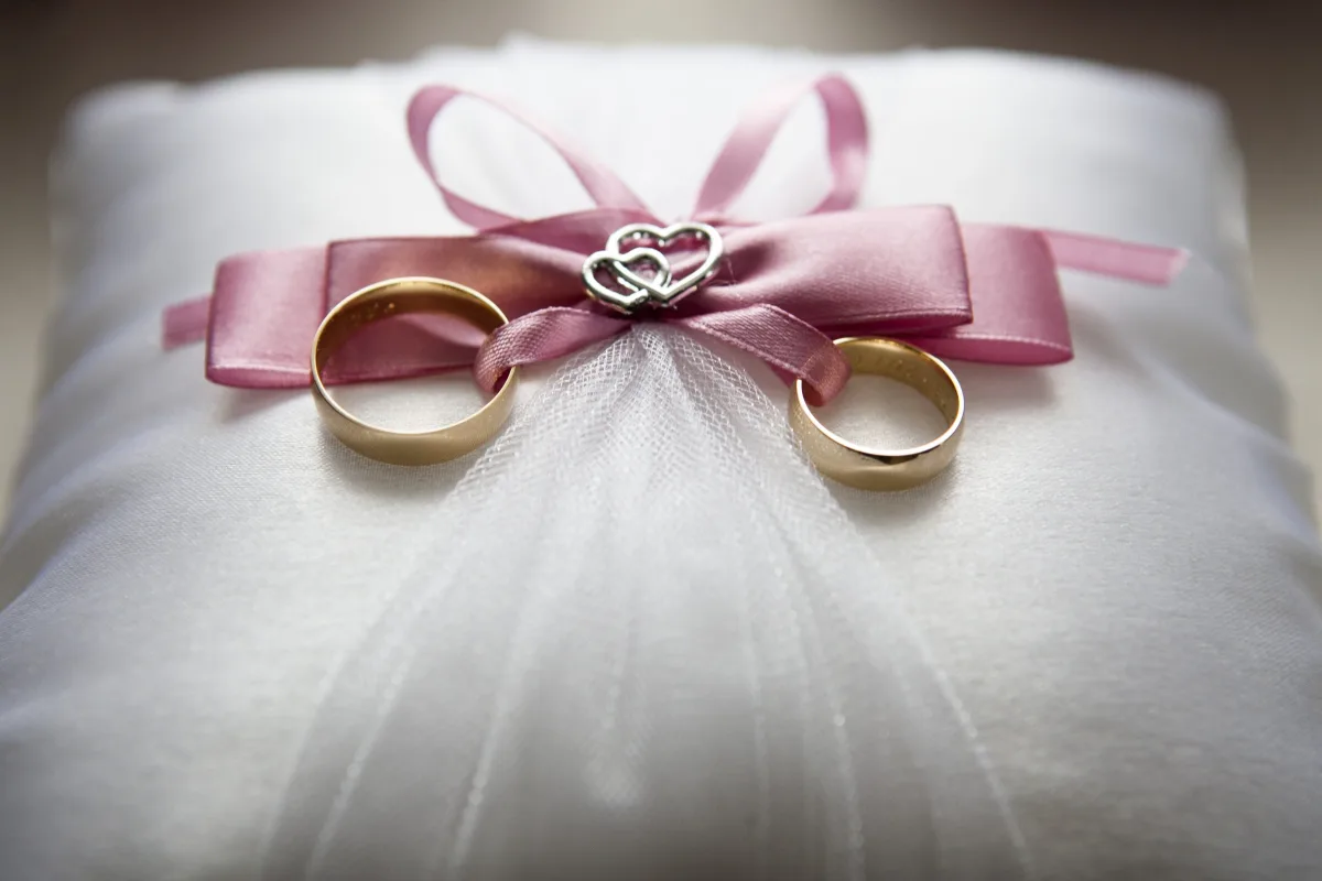 Close-up of an elegant white wedding dress with lace detailing