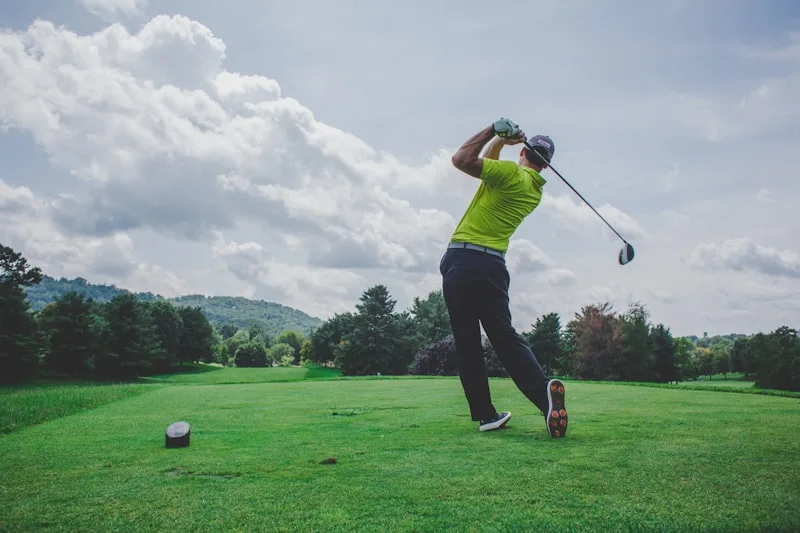 Golfer practicing iron shots at a driving range